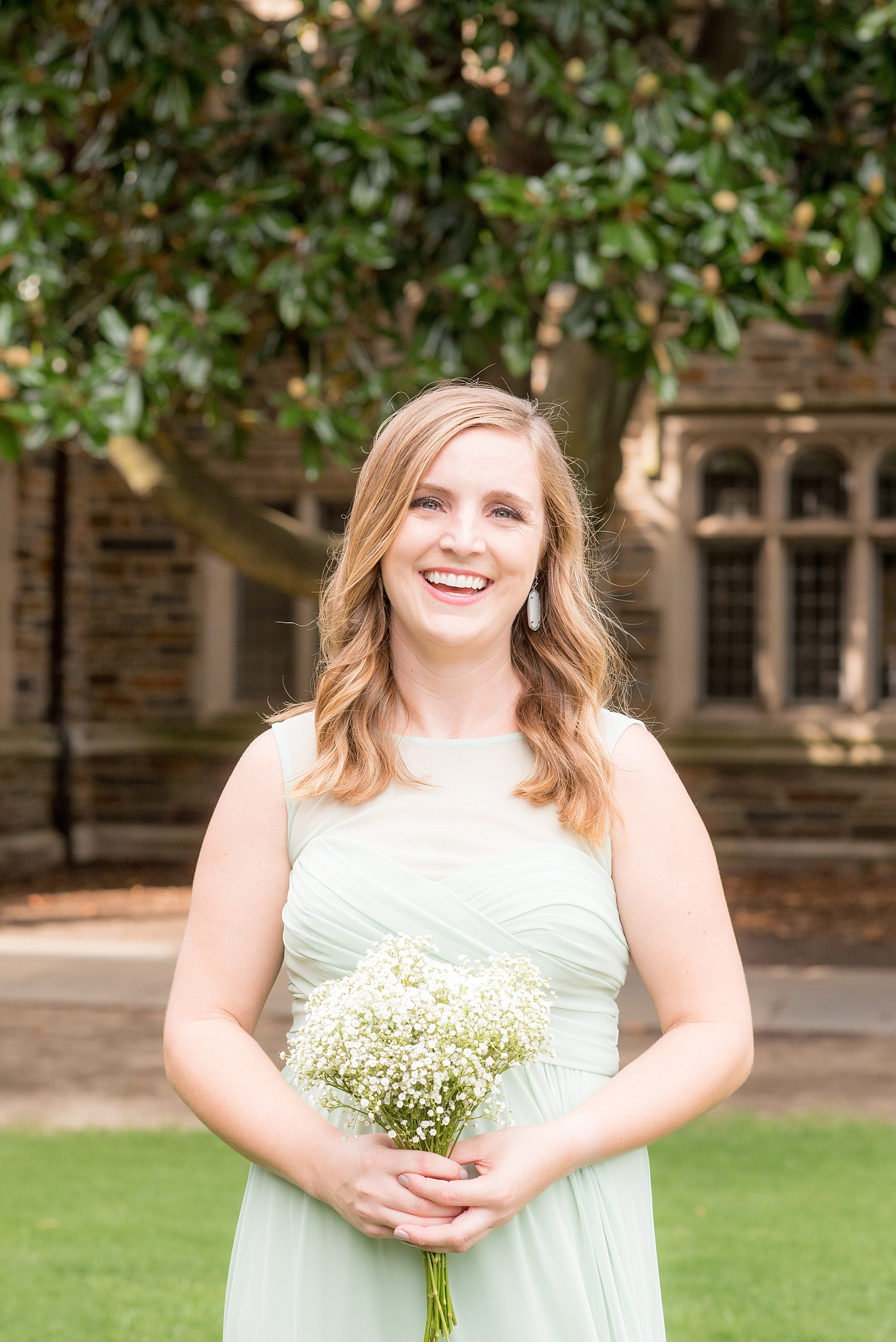 Mikkel Paige Photography photo of a Duke Chapel wedding in Durham, North Carolina. A bridesmaid in a mint green gown.