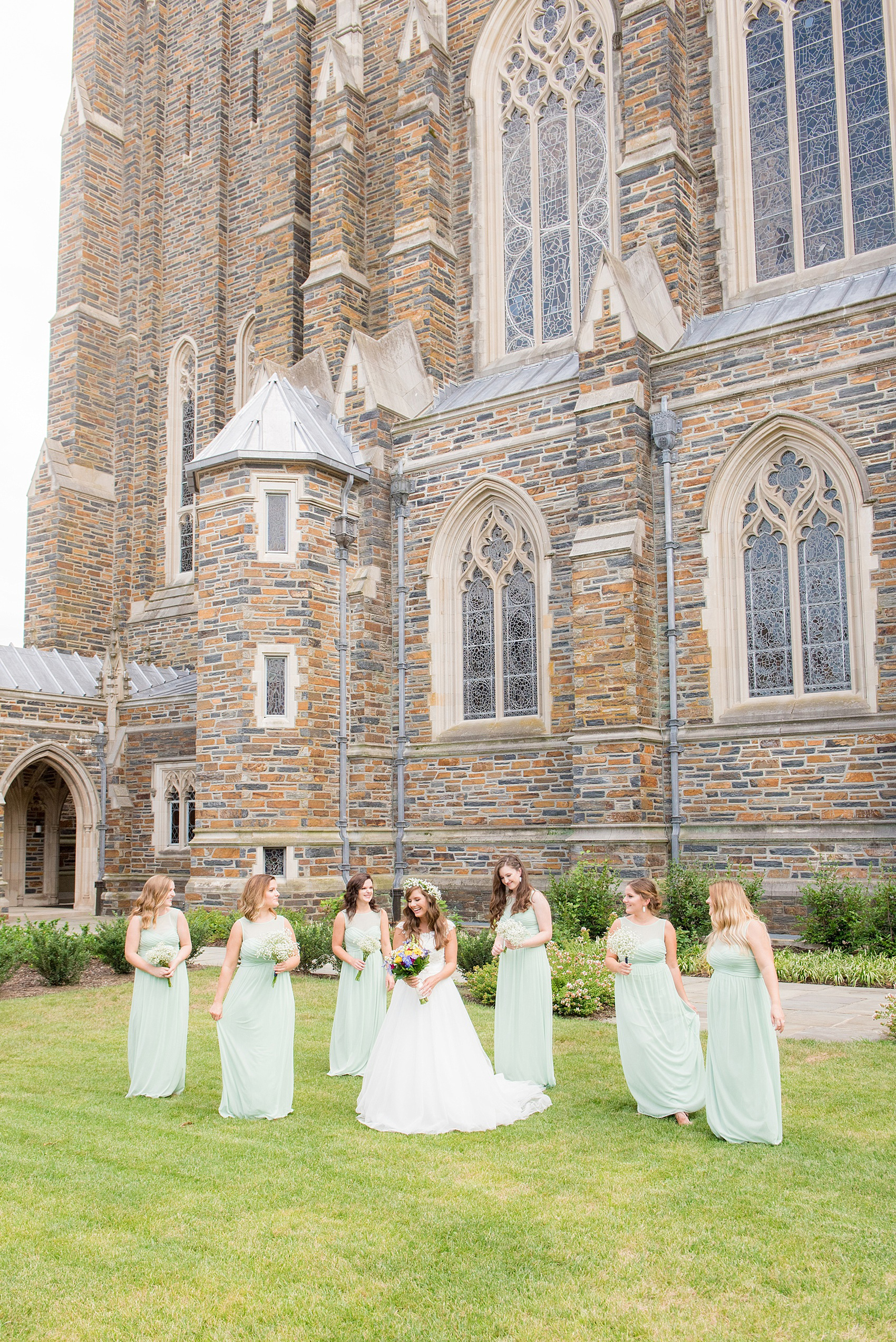 Mikkel Paige Photography photo of a Duke Chapel wedding in Durham, North Carolina. The bride in a lace cap sleeve gown and her bridesmaids mint green gowns.