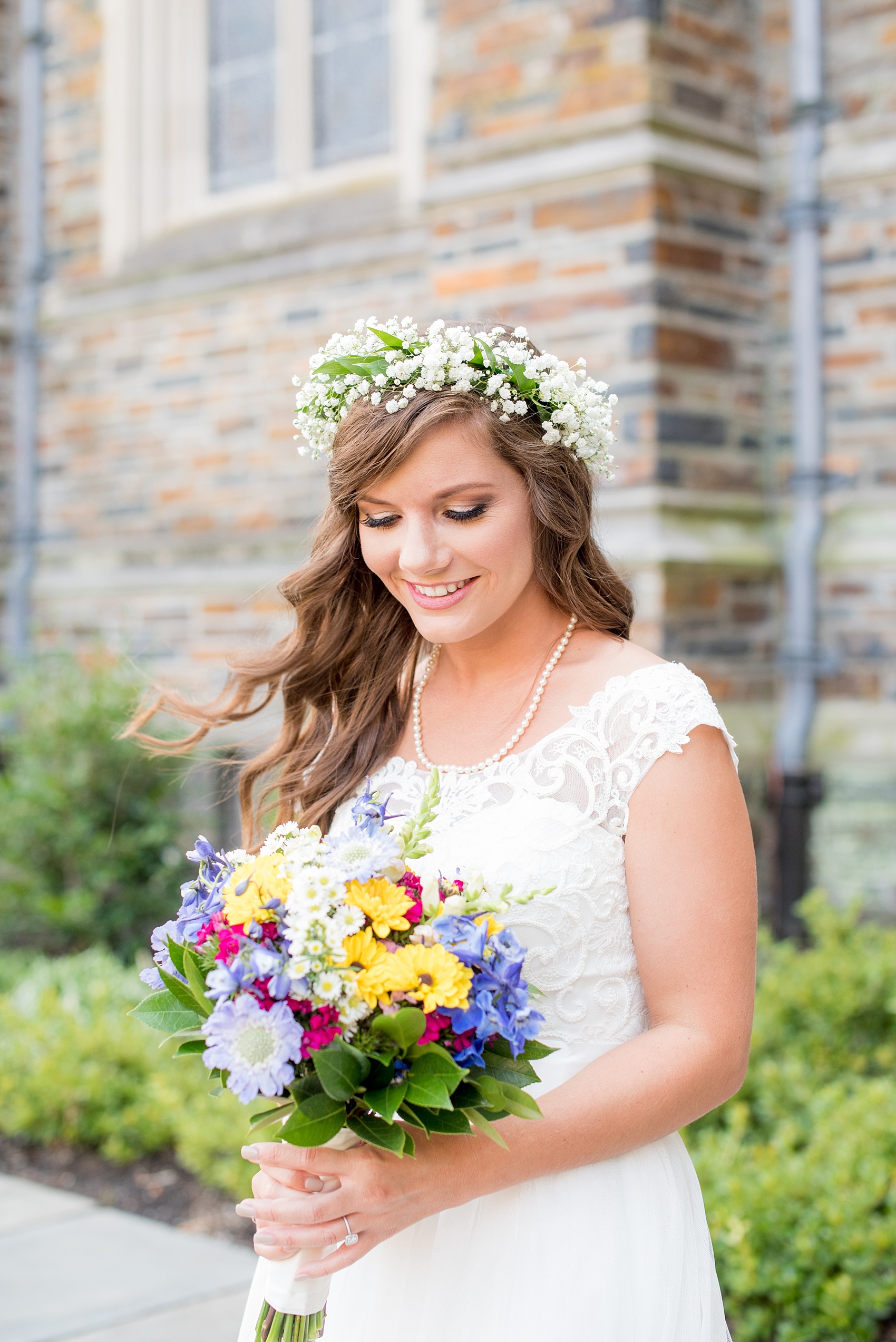 Mikkel Paige Photography photo of a Duke Chapel wedding in Durham, North Carolina. The bride in a lace cap sleeve gown with a wildflower bouquet and Baby's Breath floral crown.