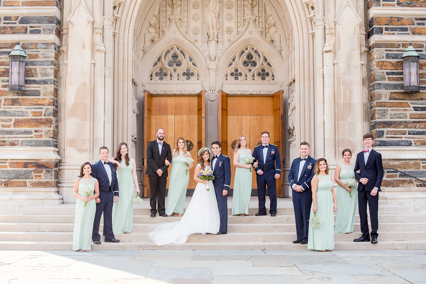 Mikkel Paige Photography photo of a Duke Chapel wedding in Durham, North Carolina. The bride, groom and bridal party in navy and mint green on the steps of the iconic gothic church.