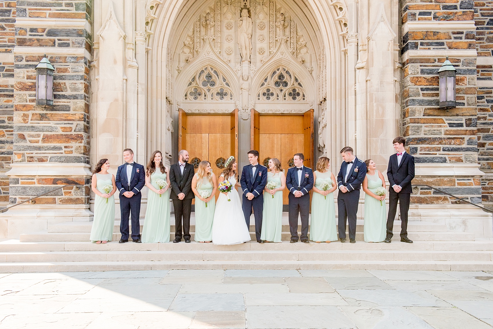 Mikkel Paige Photography photo of a Duke Chapel wedding in Durham, North Carolina. The bride, groom and bridal party in navy and mint green on the steps of the iconic gothic church.
