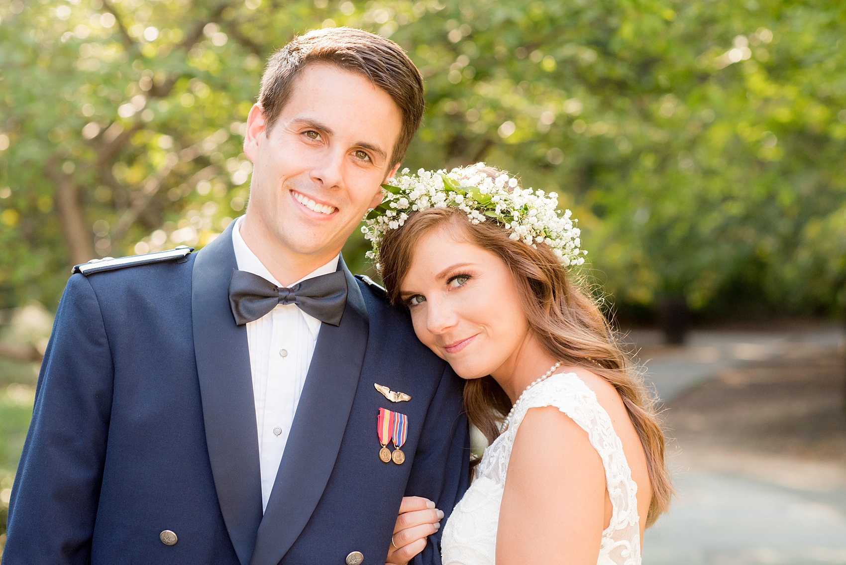 Mikkel Paige Photography photo of a Duke Chapel wedding in Durham, North Carolina. The bride in her Baby's Breath floral crown and groom in his navy blue Air Force uniform.