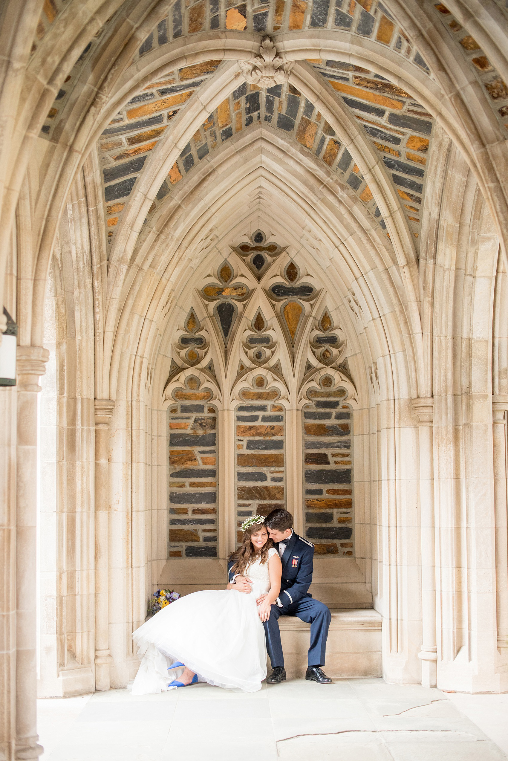 Mikkel Paige Photography photo of a Duke Chapel wedding in Durham, North Carolina. The bride in her Baby's Breath floral crown and groom in his navy blue Air Force uniform.