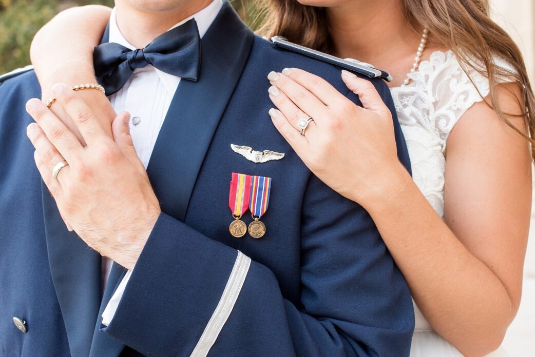 Mikkel Paige Photography photo of a Duke Chapel wedding in Durham, North Carolina. The bride and groom's wedding rings against his navy blue Air Force uniform.