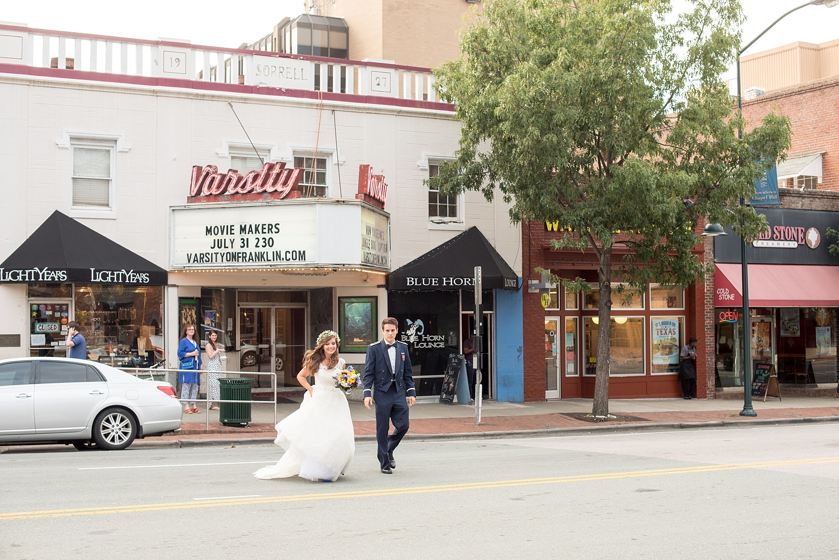 Mikkel Paige Photography photo of the bride and groom on E. Franklin St in Chapel Hill, NC in front of an iconic movie sign.