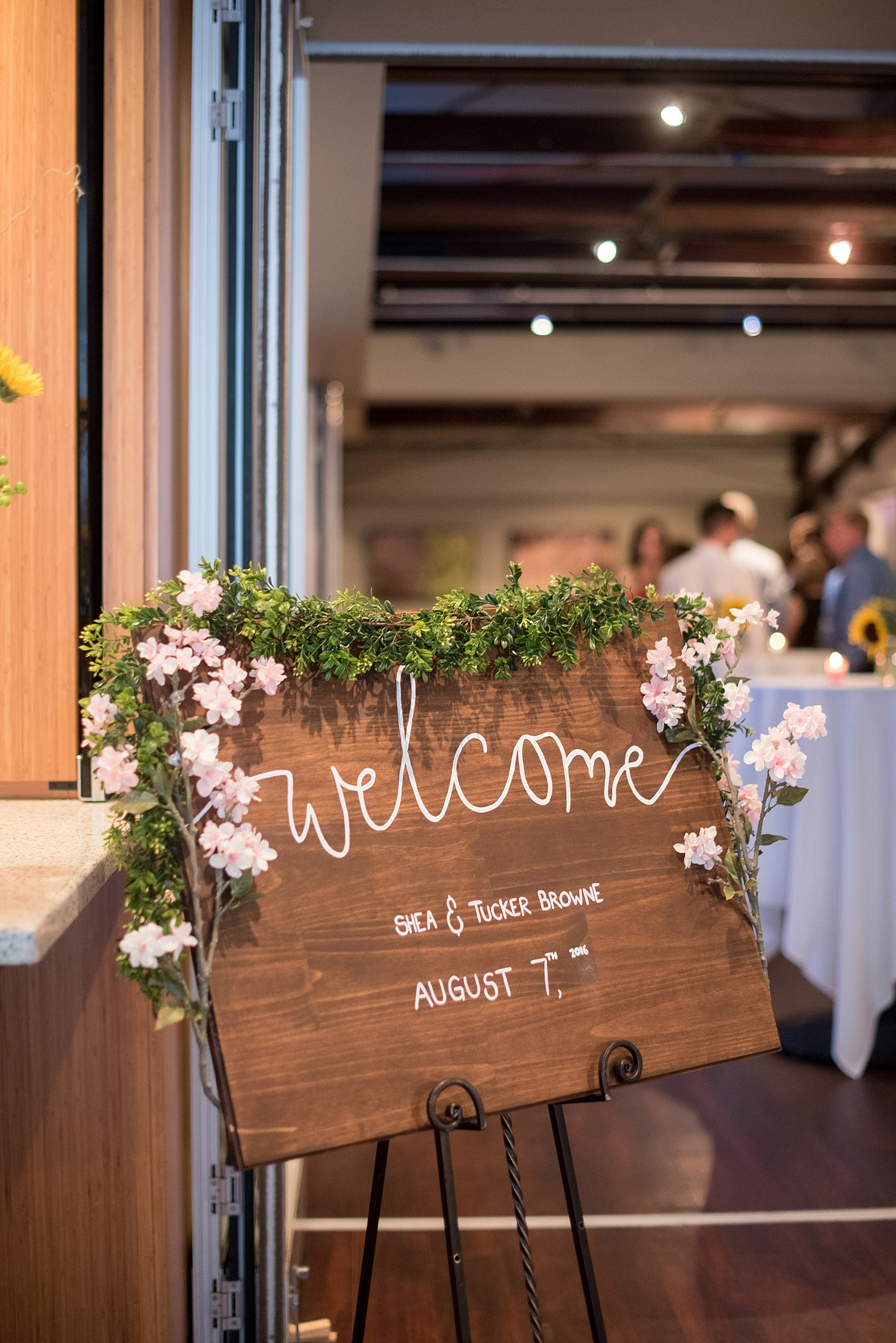 Mikkel Paige Photography photo of a wedding wooden welcome sign at Top of the Hill in Chapel Hill, NC.