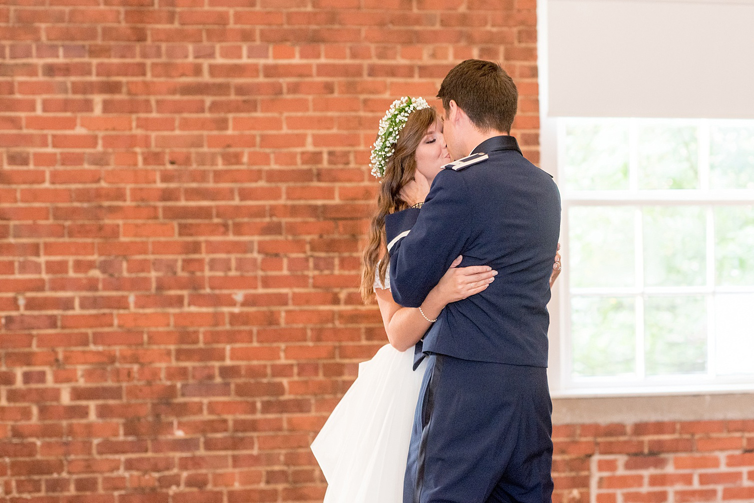 Mikkel Paige Photography photo of the bride and groom's first dance kiss at their Top of the Hill reception in Chapel Hill, NC.