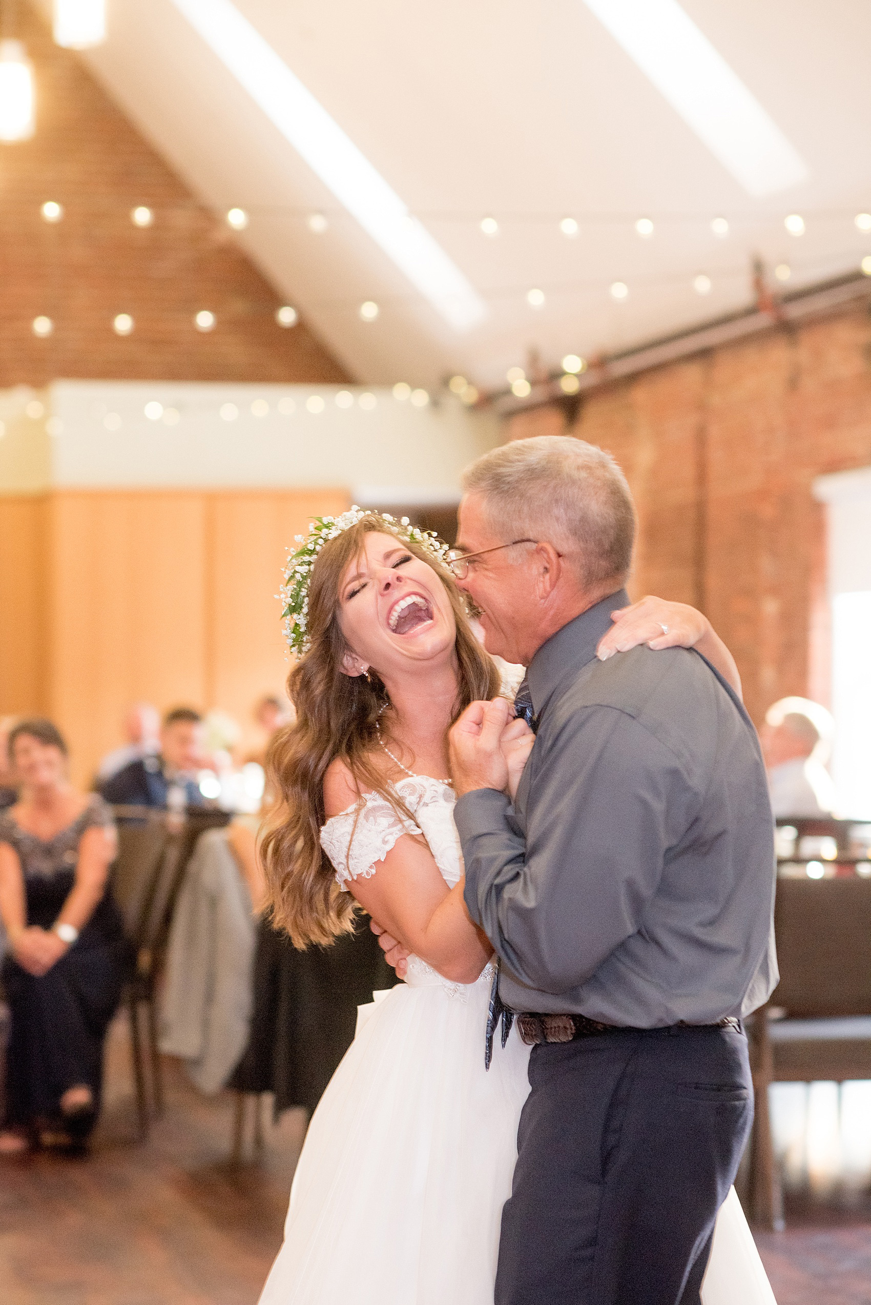 Mikkel Paige Photography photo of a Top of the Hill reception in Chapel Hill, NC. The bride shares a joyful dance with her father to "My Girl."