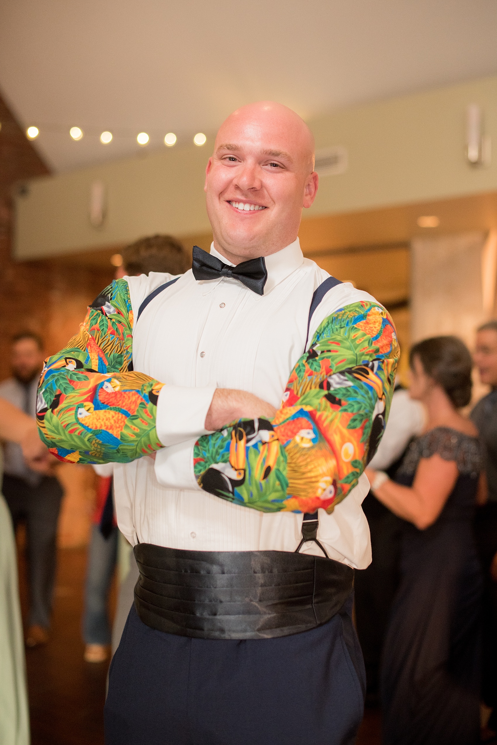 Mikkel Paige Photography photo of a Top of the Hill reception in Chapel Hill, NC with a guest in a bow tie and unique tuxedo shirt.