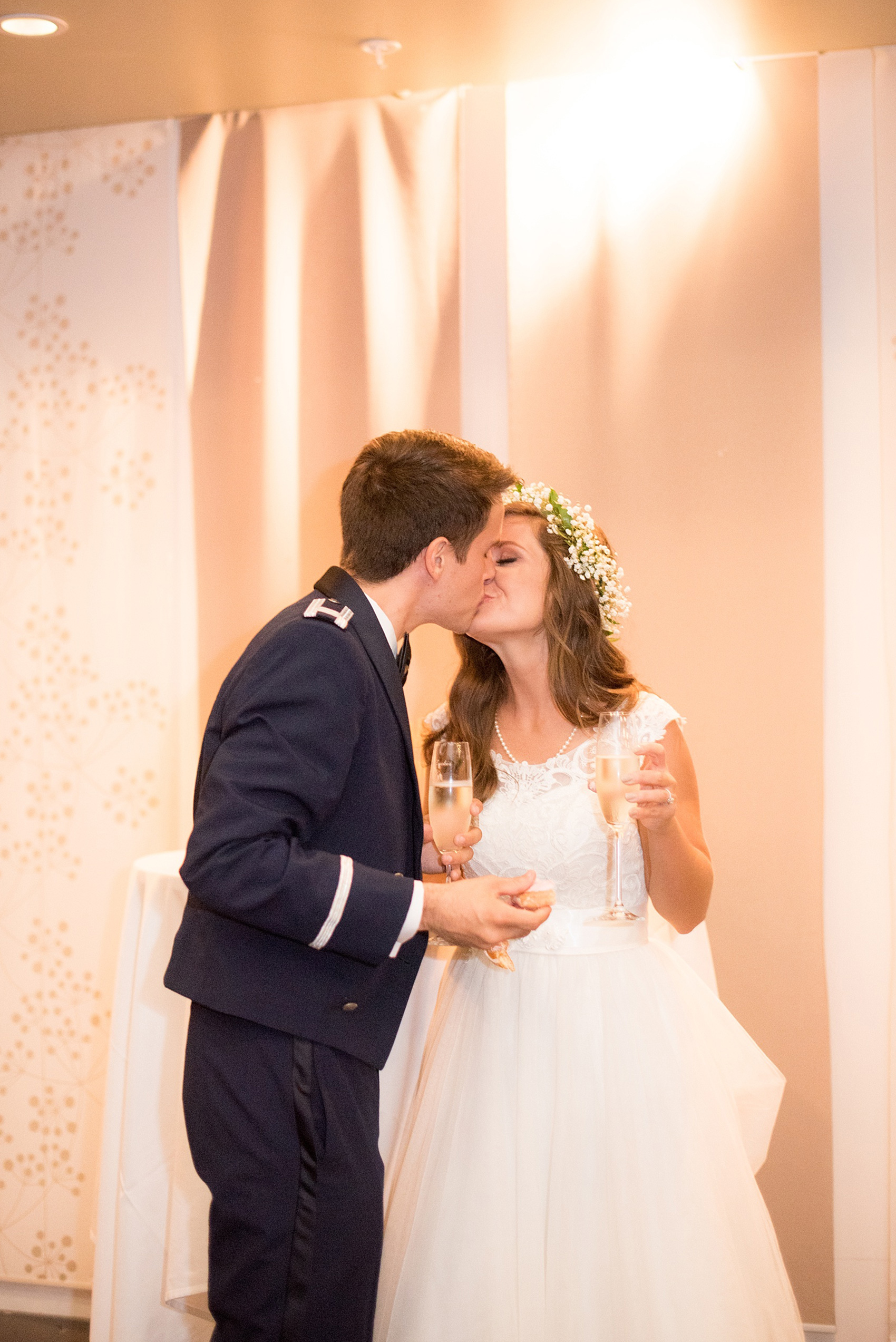 Mikkel Paige Photography photo of a Top of the Hill reception in Chapel Hill, NC with the bride and groom sharing a kiss and a toast!