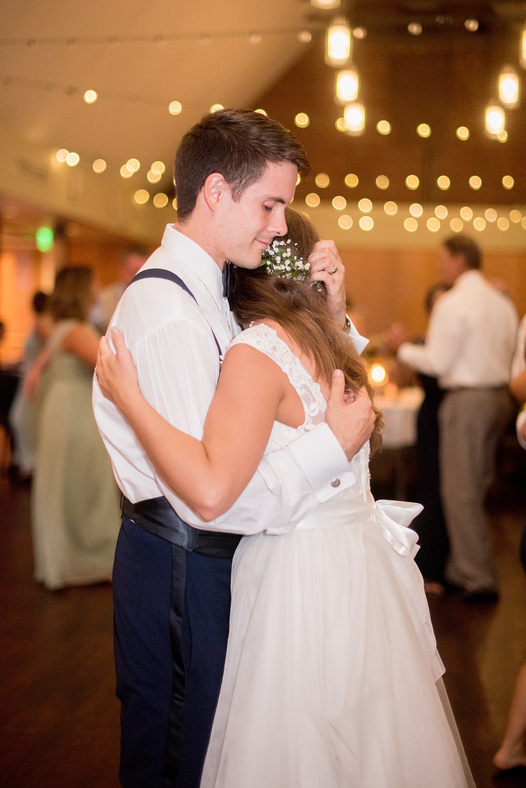 Mikkel Paige Photography photo of a Top of the Hill reception in Chapel Hill, NC with the bride and groom sharing a dance floor hug.