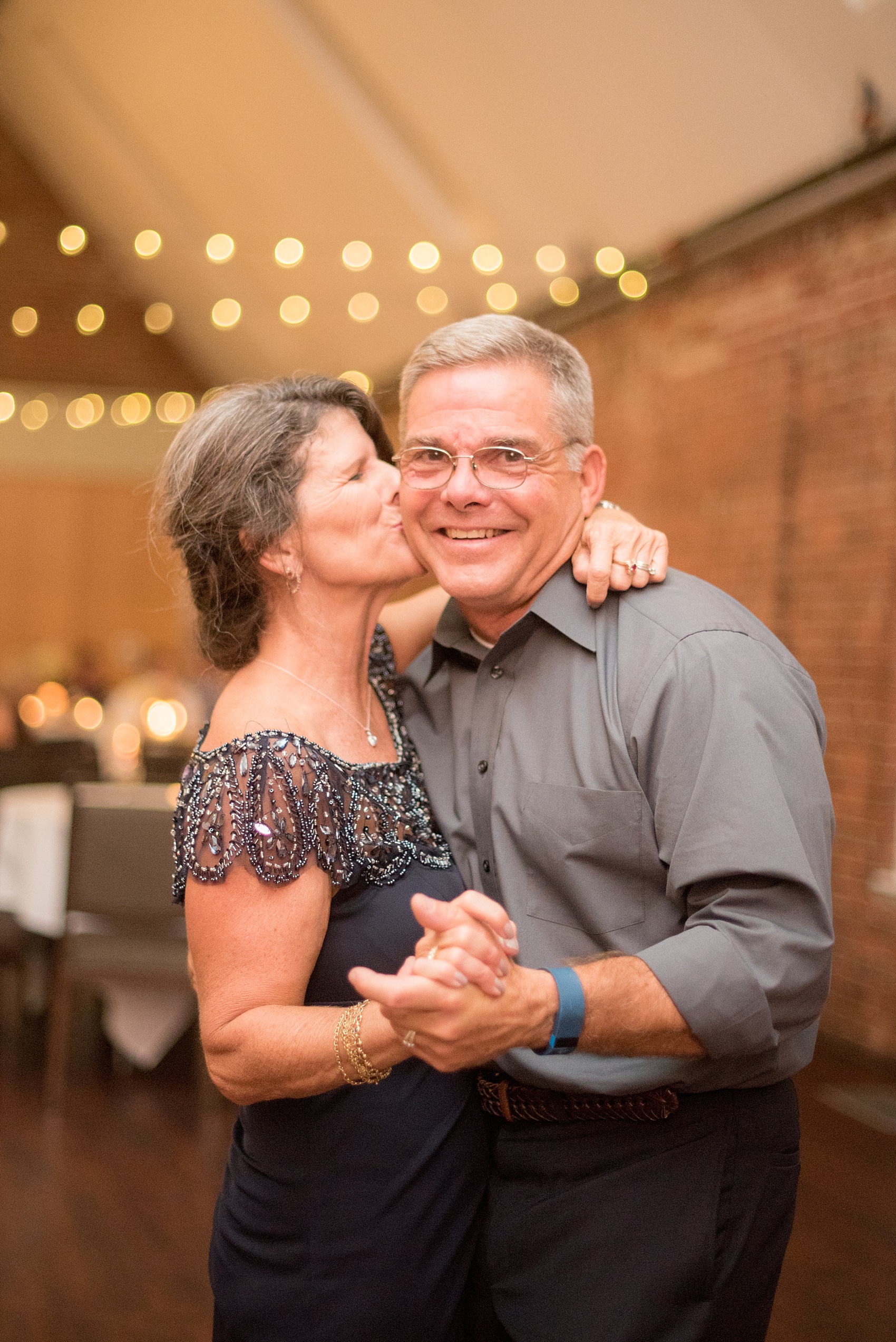 Mikkel Paige Photography photo of a Top of the Hill reception in Chapel Hill, NC with the parents of the bride dancing.