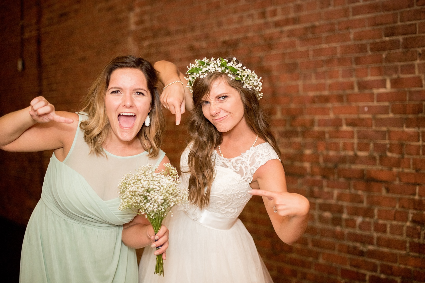 Mikkel Paige Photography photo of a Top of the Hill reception in Chapel Hill, NC with the bride and her sister, who caught the bouquet.