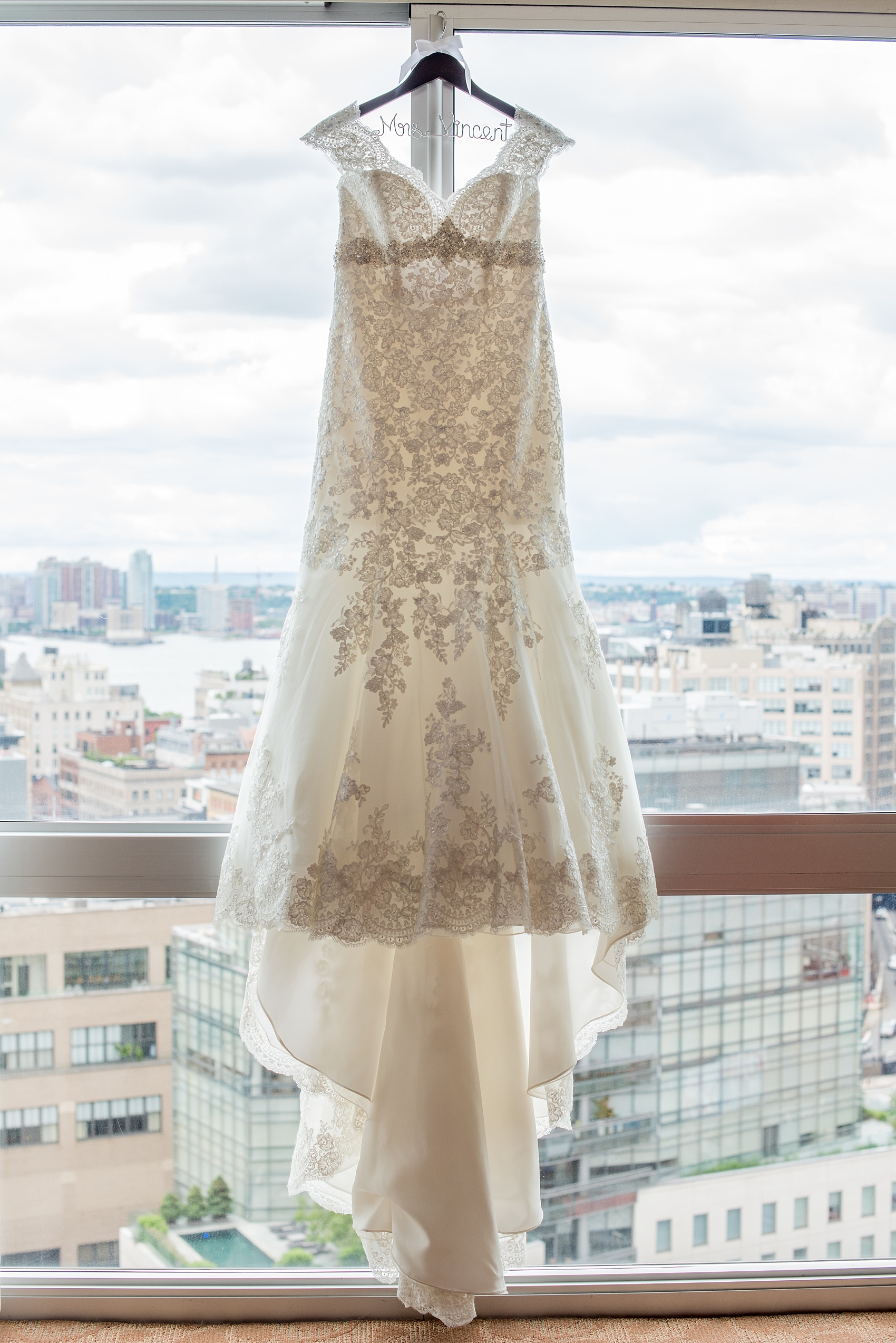 Mikkel Paige Photography photos of a NYC wedding at Tribeca Rooftop. The bride wore a cap sleeve lace gown.