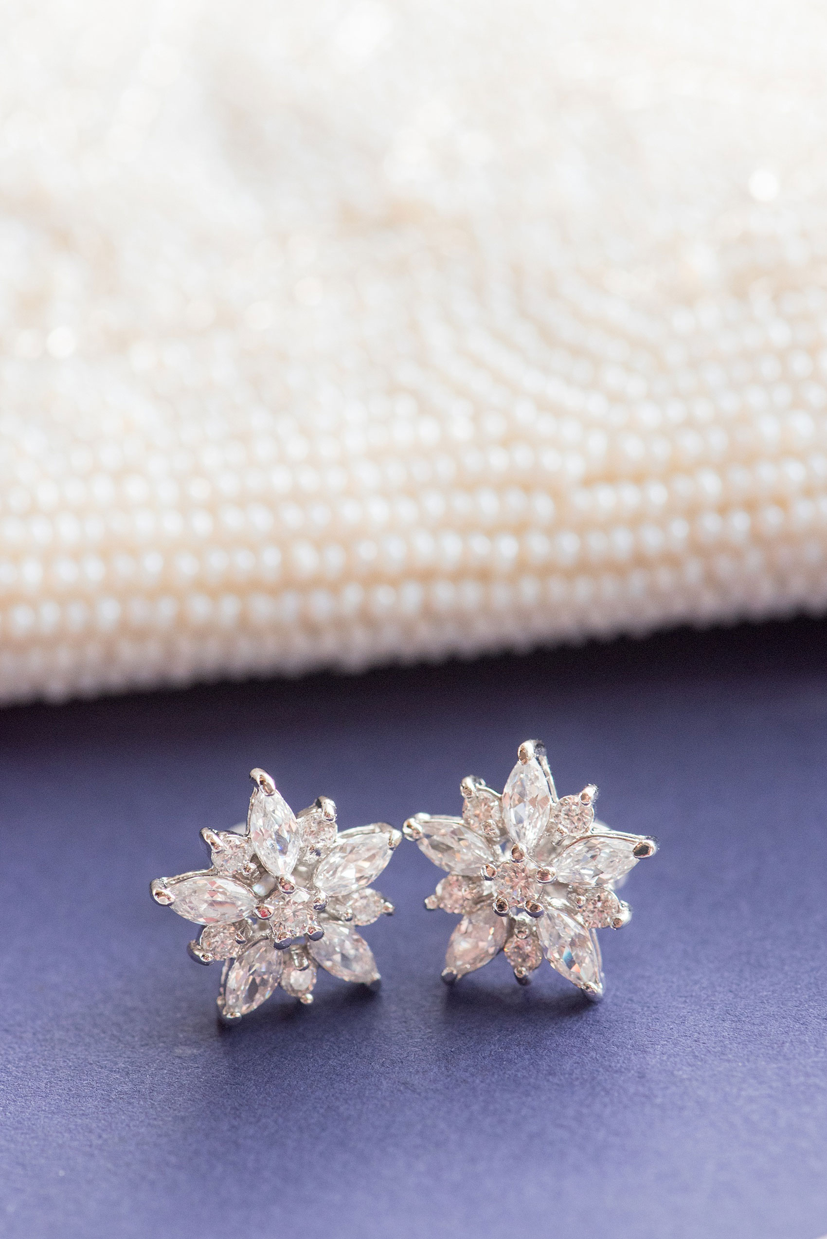 Mikkel Paige Photography photos of a NYC wedding at Tribeca Rooftop. An image of the bride's diamond flower earrings and heirloom beaded purse.