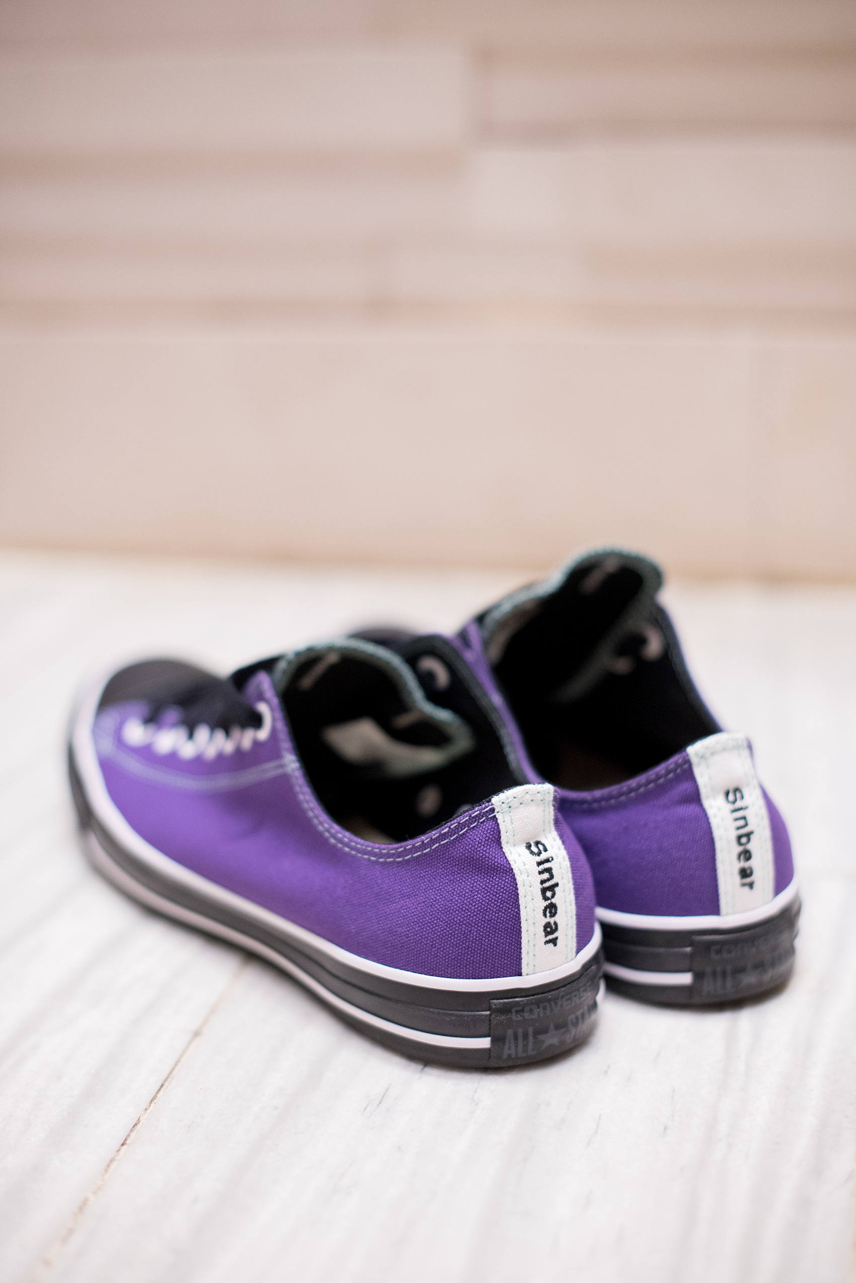 Mikkel Paige Photography photos of a NYC wedding at Tribeca Rooftop. Custom purple Converse for the groom!