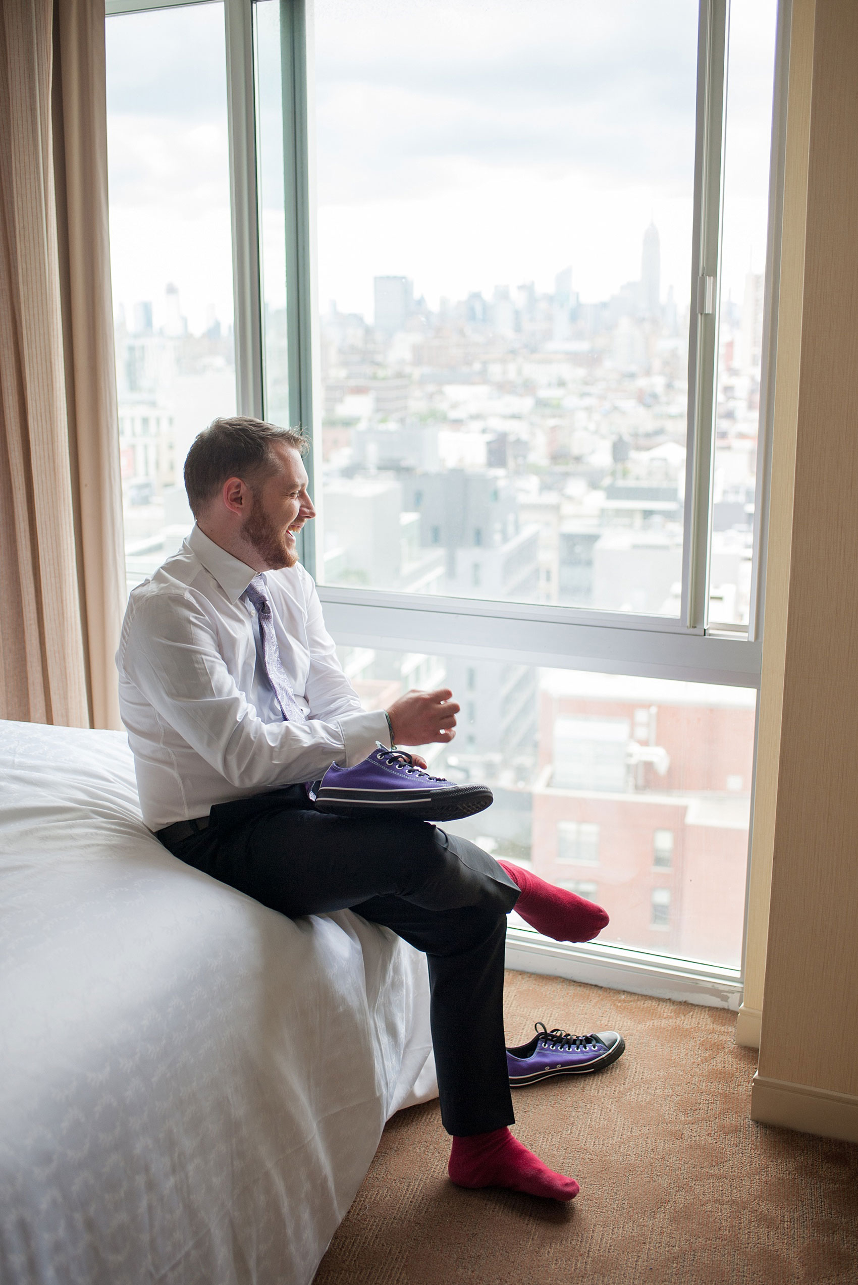 Mikkel Paige Photography photos of a NYC wedding at Tribeca Rooftop. Custom purple Converse for the groom!