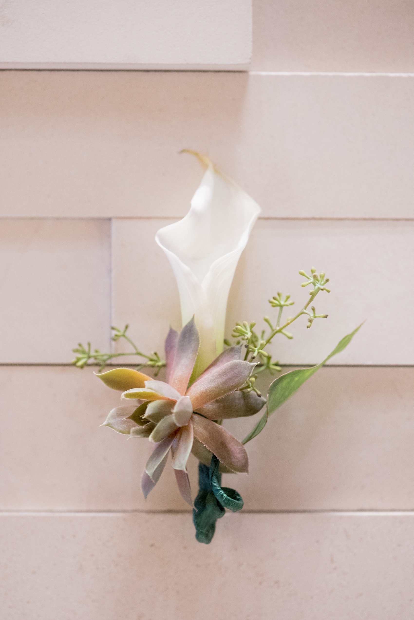 Mikkel Paige Photography photos of a NYC wedding at Tribeca Rooftop. Succulent and calla lily boutonniere.
