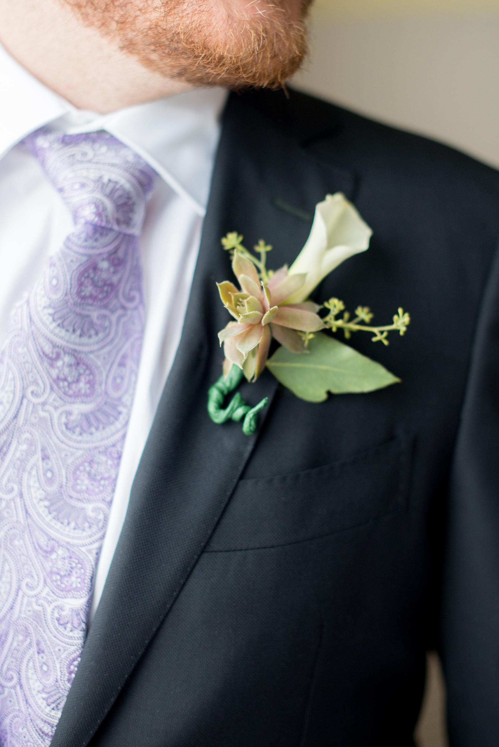 Mikkel Paige Photography photos of a NYC wedding at Tribeca Rooftop. Succulent and calla lily boutonniere and purple paisley tie.