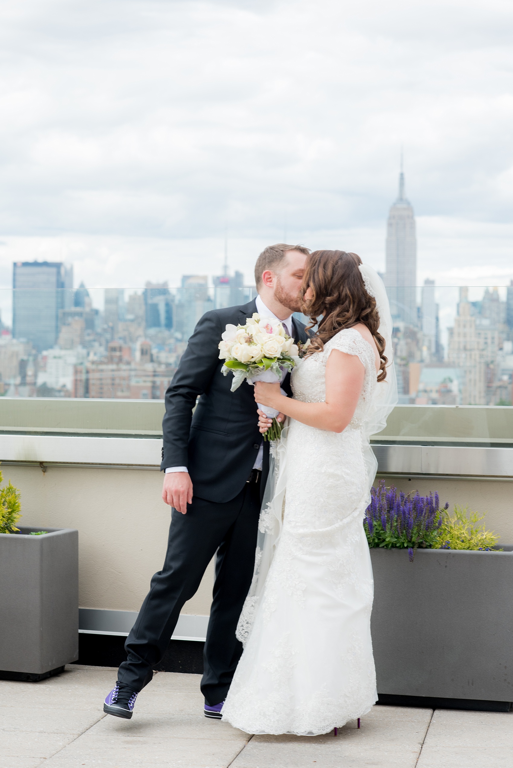 Mikkel Paige Photography photos of a NYC wedding at Tribeca Rooftop. First look with the Manhattan Skyline and Empire State Building.
