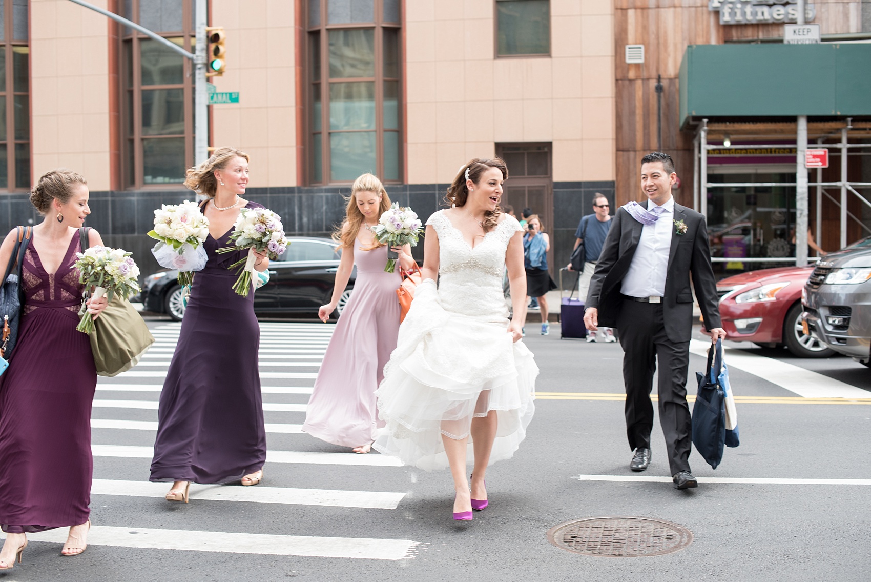 Mikkel Paige Photography photos of a NYC wedding at Tribeca Rooftop. The bridal party crosses a street in lower Manhattan.