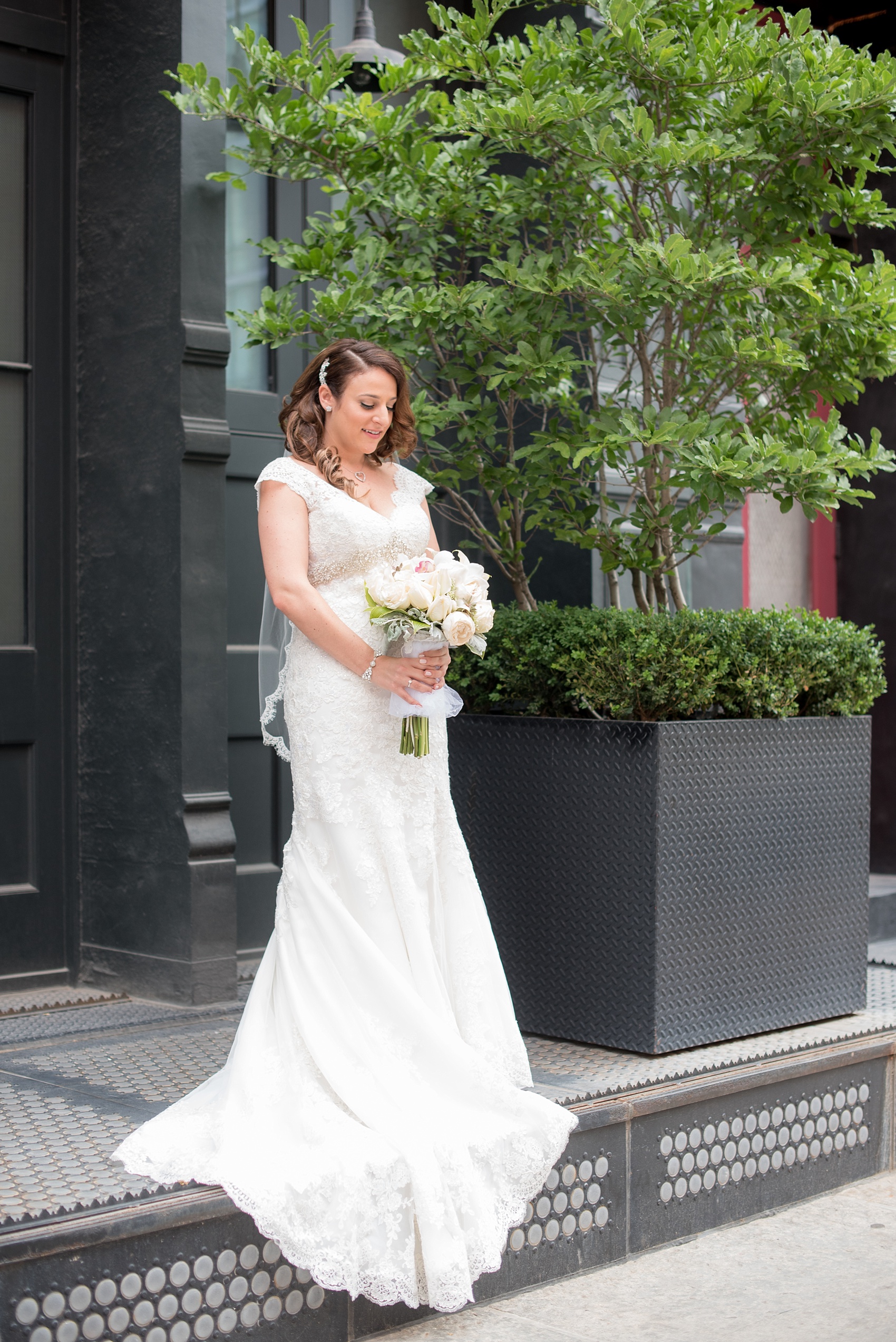 Mikkel Paige Photography photos of a NYC wedding at Tribeca Rooftop. The bride wore a lace cap sleeve Alita Graham dress from Kleinfeld's.