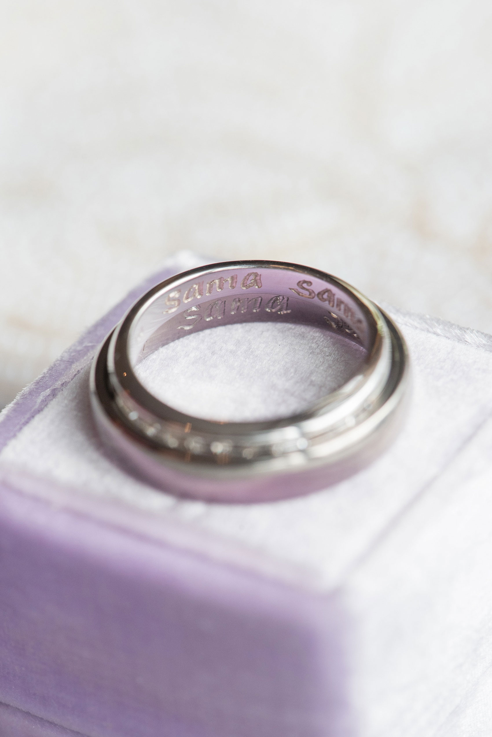 Mikkel Paige Photography photos of a NYC wedding at Tribeca Rooftop. An image of the inscription in the white gold wedding bands.