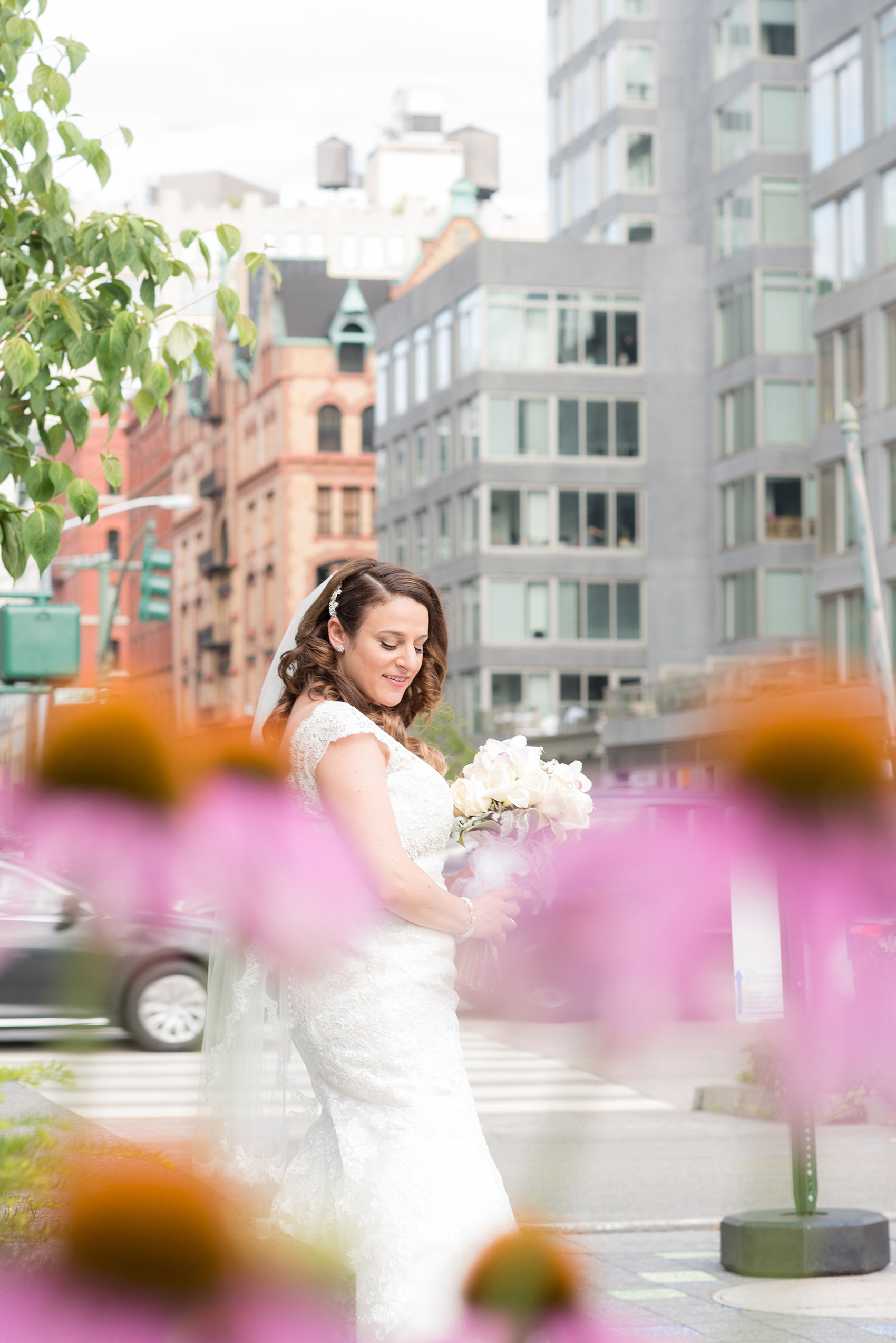 Mikkel Paige Photography photos of a NYC wedding at Tribeca Rooftop. An image of the bride in her Anita Graham lace gown at Hudson River Park.