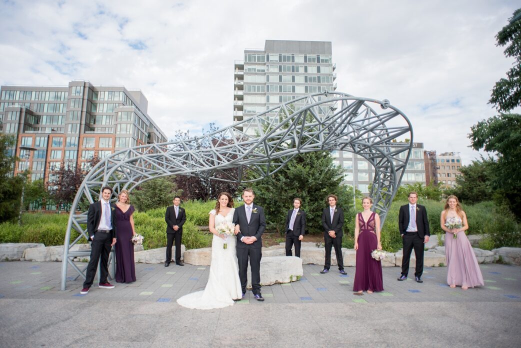 Mikkel Paige Photography photos of a NYC wedding at Tribeca Rooftop. An image of the wedding party/bridal party with a sculpture at Hudson River Park.