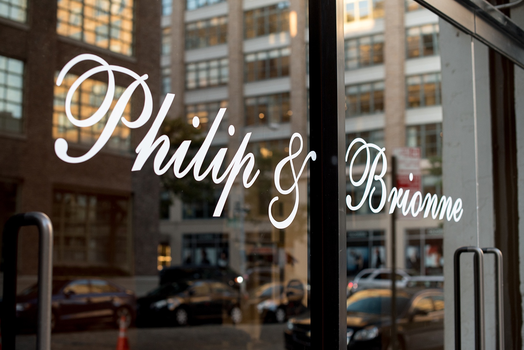 Mikkel Paige Photography photos of a NYC wedding at Tribeca Rooftop. An image of the custom decal of the groom and bride's names on the doors of the venue.