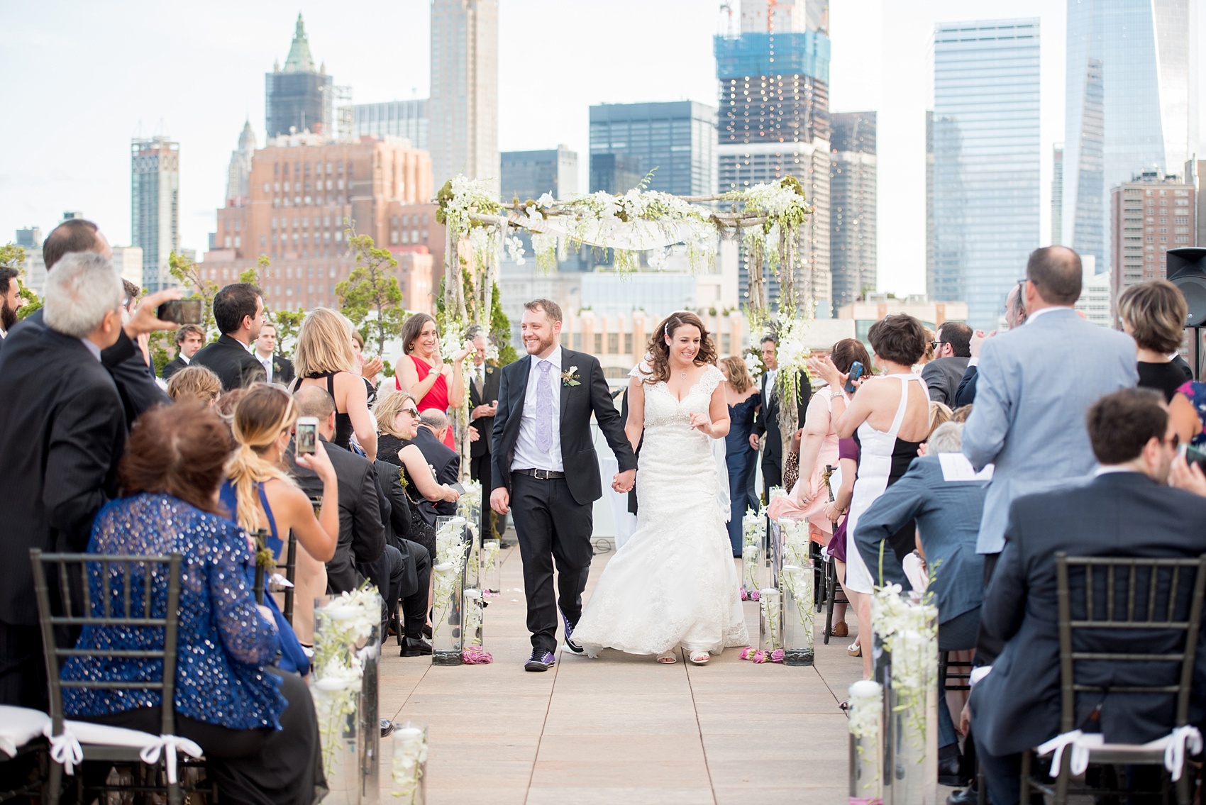 Mikkel Paige Photography photos of a NYC wedding at Tribeca Rooftop. An image of the outdoor ceremony with Freedom Tower in the background.