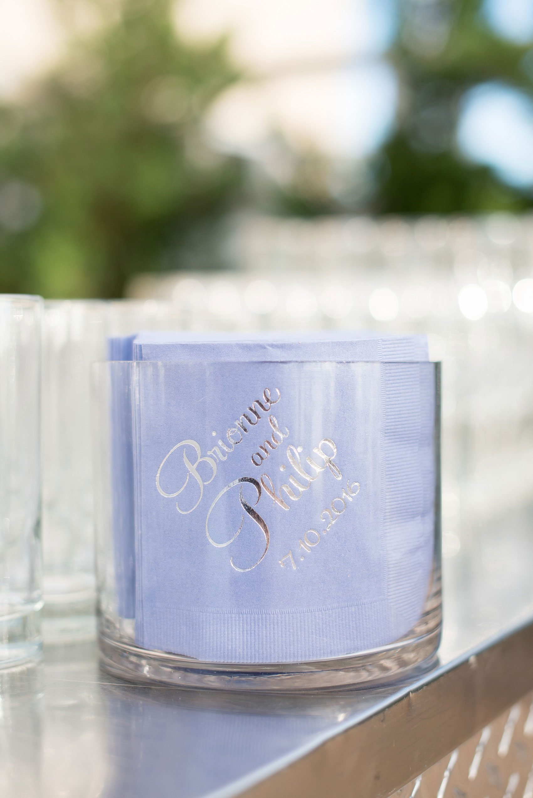 Mikkel Paige Photography photos of a NYC wedding at Tribeca Rooftop. An image of the cocktail hour custom purple and silver napkins.