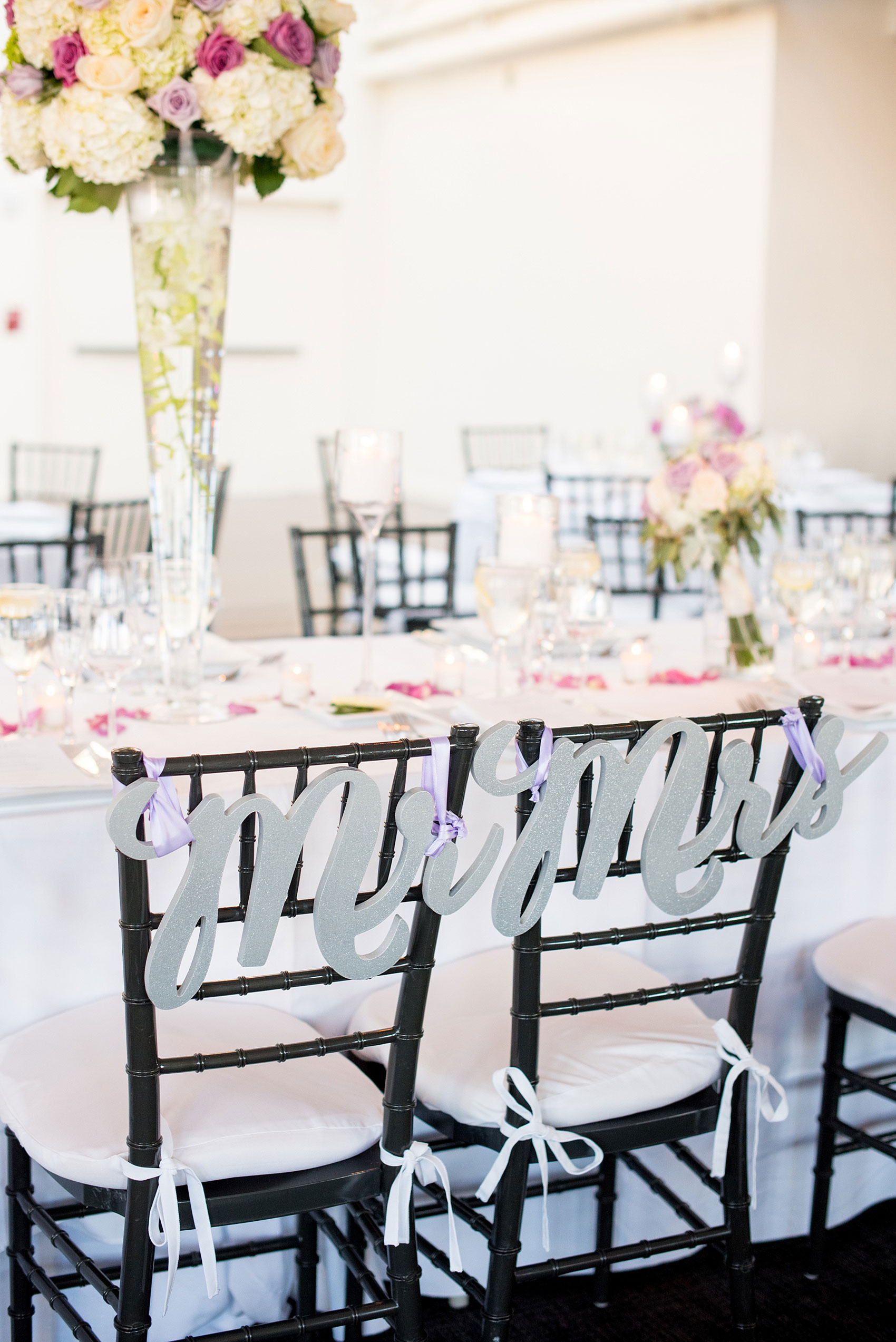 Mikkel Paige Photography photos of a NYC wedding at Tribeca Rooftop. An image of the laser cut silver Mr. and Mrs. chair signs.