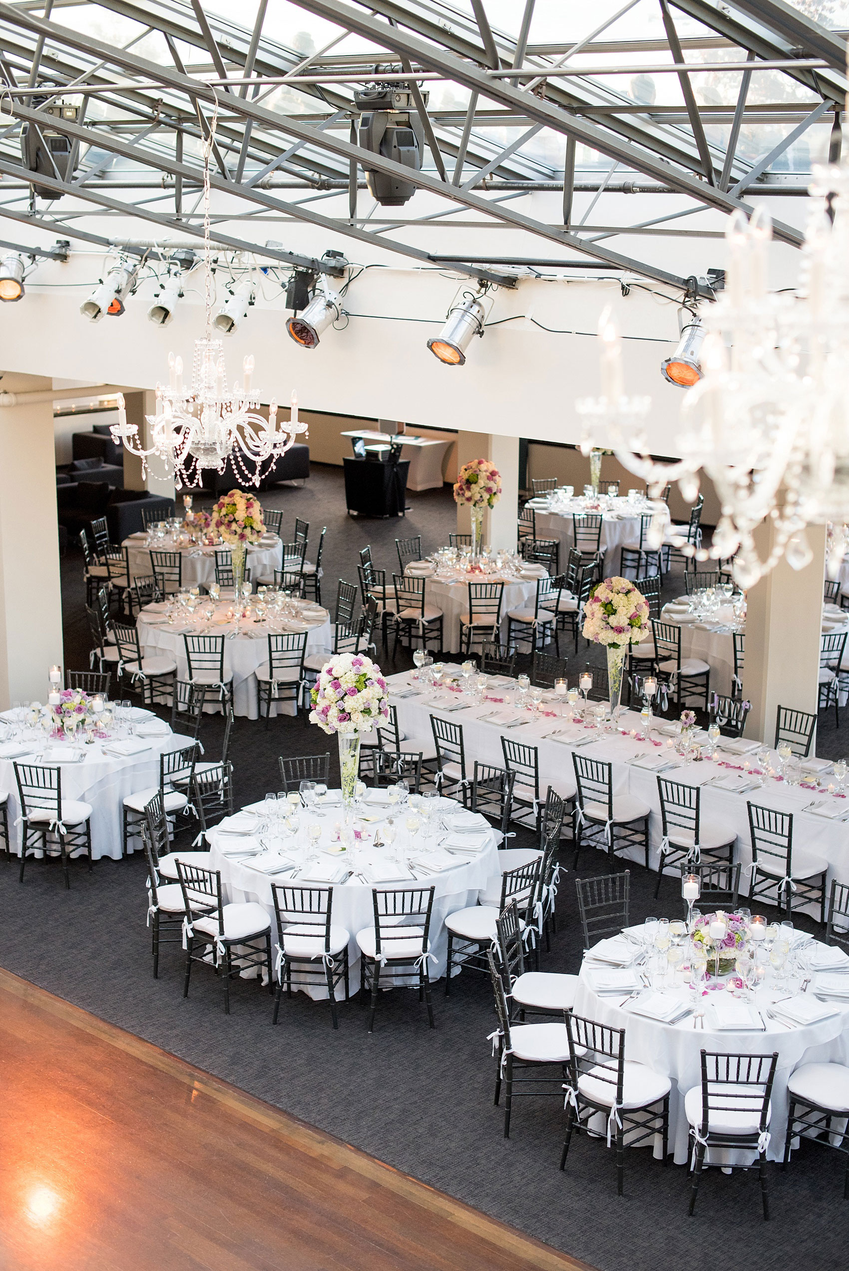 Mikkel Paige Photography photos of a NYC wedding at Tribeca Rooftop. An image of the reception with candlelight and purple flowers.