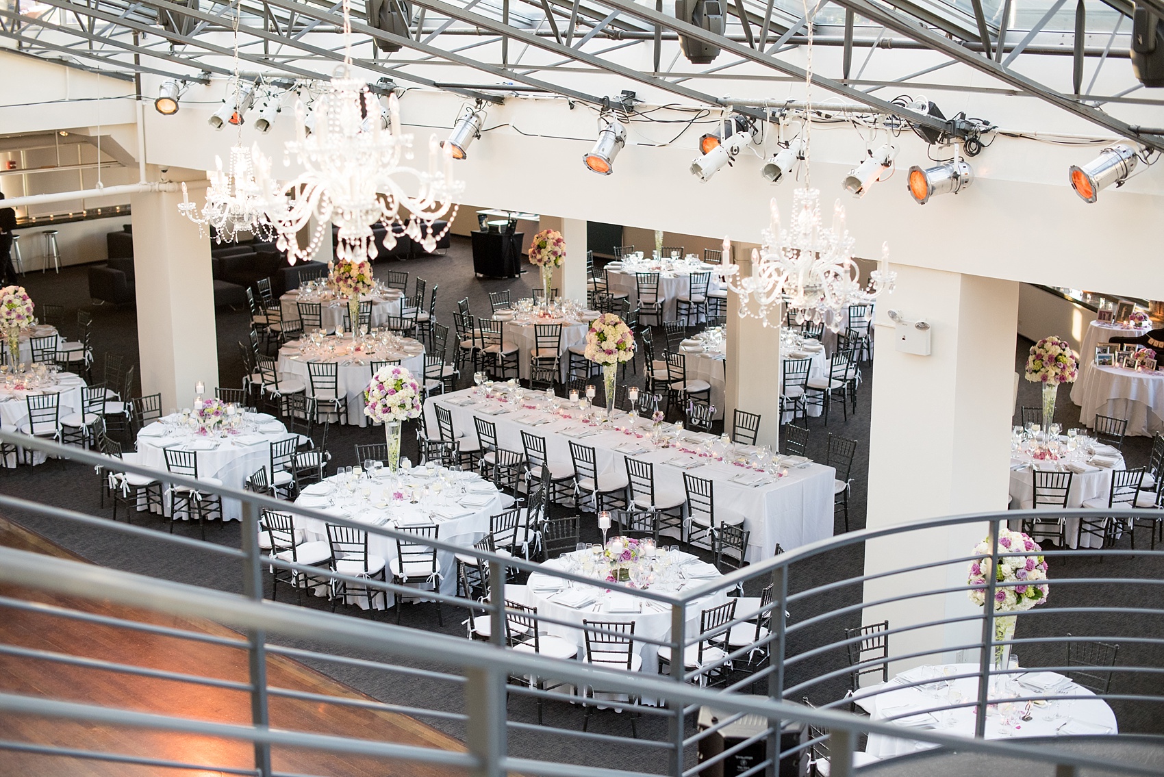 Mikkel Paige Photography photos of a NYC wedding at Tribeca Rooftop. An image of the reception with candlelight and purple flowers.