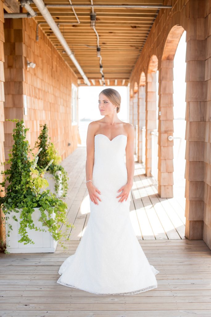 Mikkel Paige Photography photos of a Bay Head Yacht Club nautical wedding. The bride wore a low back sweetheart neckline gown from Kleinfeld and a low bun hari do.