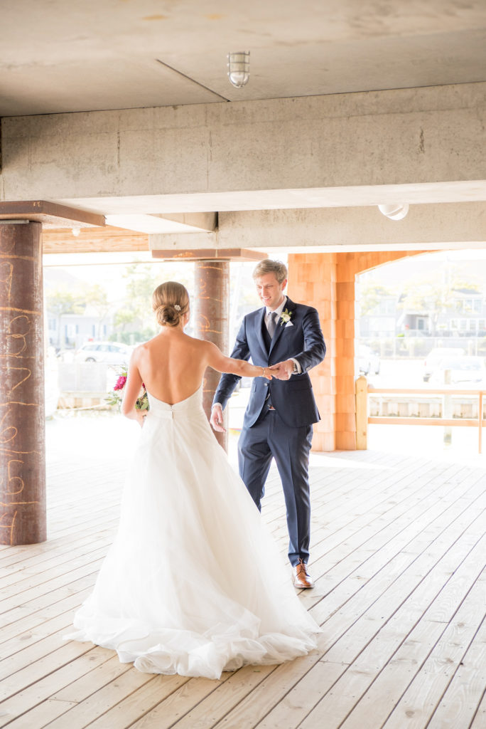 Mikkel Paige Photography photos of a Bay Head Yacht Club nautical wedding. The bride and groom share their first look.