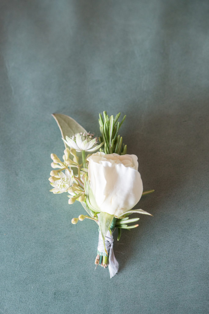 Mikkel Paige Photography photos of a Bay Head Yacht Club nautical wedding. The groom wore a white rose and rosemary boutonniere.