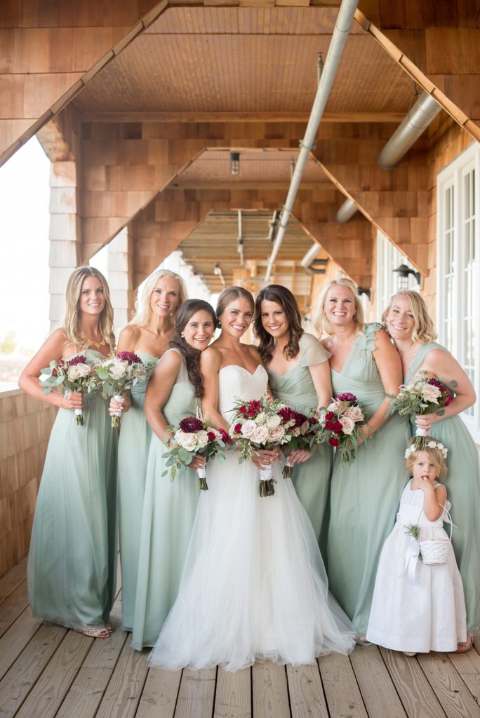 Mikkel Paige Photography photos of a Bay Head Yacht Club nautical wedding. The bride wore a white sweetheart gown and her bridesmaids wore mint green Amsale gowns.