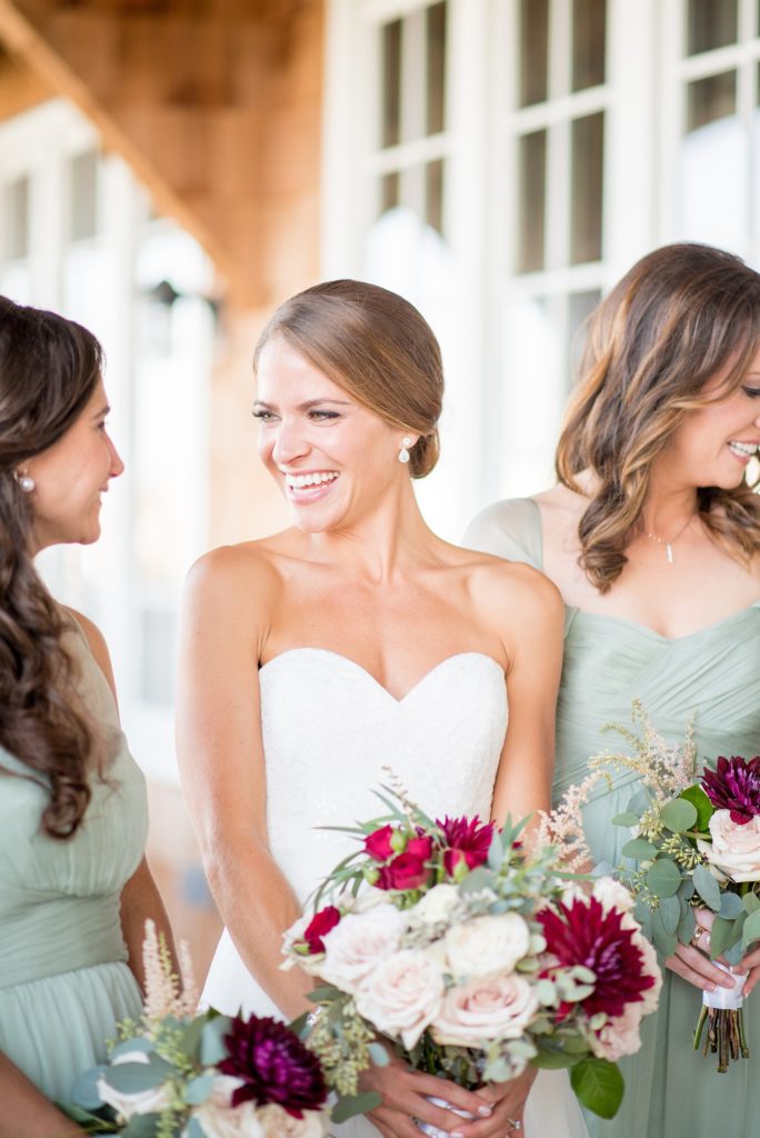 Mikkel Paige Photography photos of a Bay Head Yacht Club nautical wedding. The bride wore a white sweetheart gown and her bridesmaids wore mint green Amsale gowns.