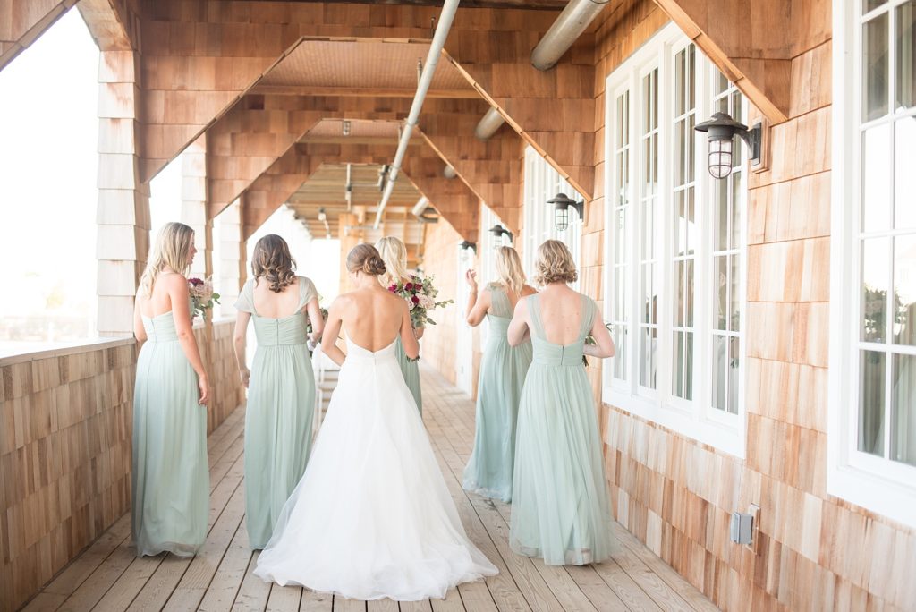 Mikkel Paige Photography photos of a Bay Head Yacht Club nautical wedding. The bride wore a white sweetheart gown and her bridesmaids wore mint green Amsale gowns.