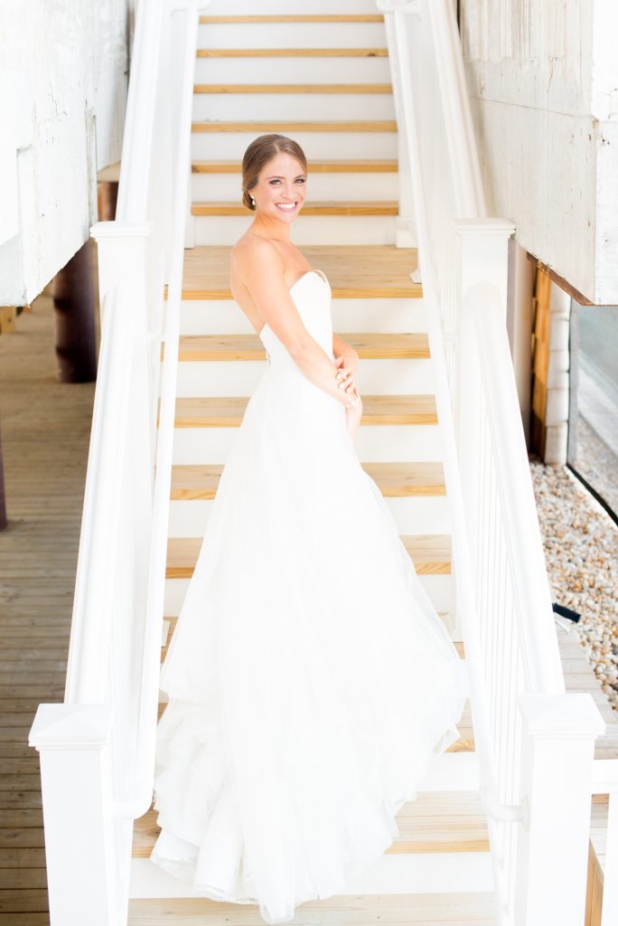 Mikkel Paige Photography photos of a Bay Head Yacht Club nautical wedding. The bride wore a white sweetheart neckline gown with lace and white sequins from Kleinfeld bridal.