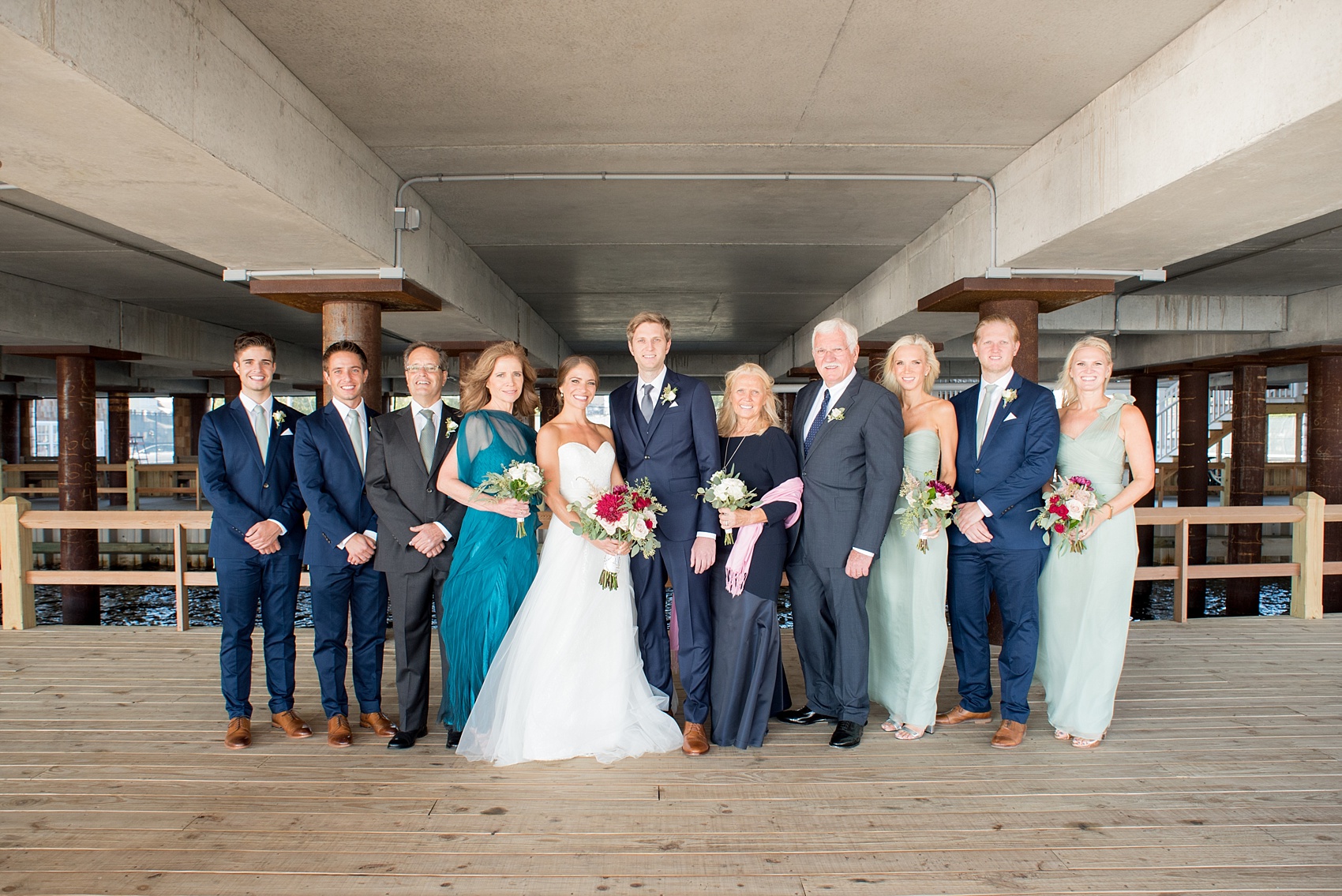 Mikkel Paige Photography picture of a Bay Head Yacht Club nautical wedding. The bride and groom's family pose for a photo.