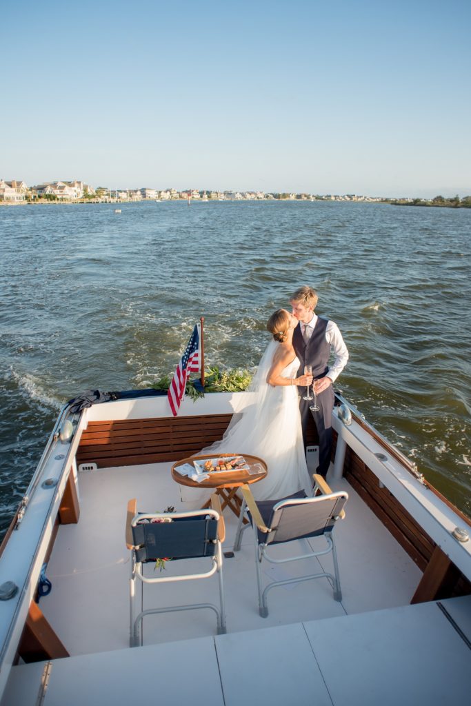 Mikkel Paige Photography picture of a Bay Head Yacht Club nautical wedding. The bride and groom took a vintage 1950's boat to their reception.