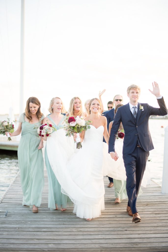 Mikkel Paige Photography picture of a Bay Head Yacht Club nautical wedding. The bride and groom arrive to their reception on the water.