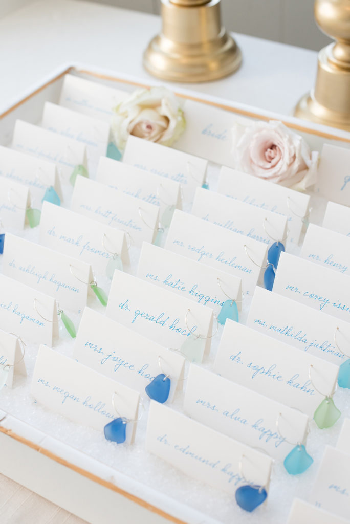 Nautical themed fall wedding at Bay Head Yacht Club in New Jersey, by Mikkel Paige Photography (@mikkelpaige) featured in The Knot. Beach glass was fastened to escort cards for guests and served as their favors.