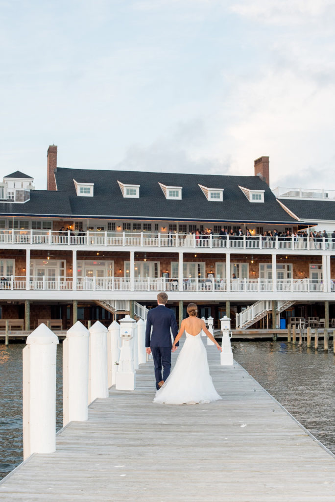 Mikkel Paige Photography picture of a Bay Head Yacht Club nautical wedding. The bride and groom arrive to their reception on the water.