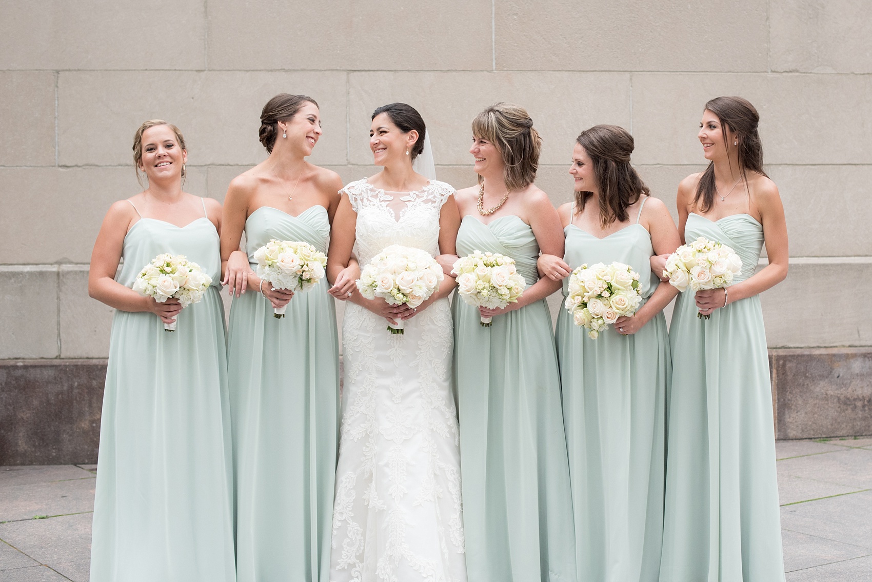 Mikkel Paige Photography photos of a wedding in downtown Chicago. The bridesmaids in mint green gowns and bride in lace at Riverwalk.