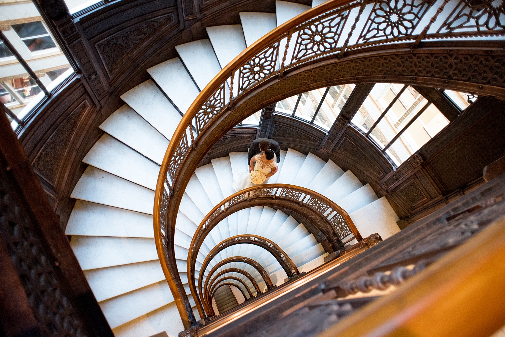 Mikkel Paige Photography photos of a wedding in downtown Chicago. An image of the bride and groom on the spiral stairs of The Rookery.