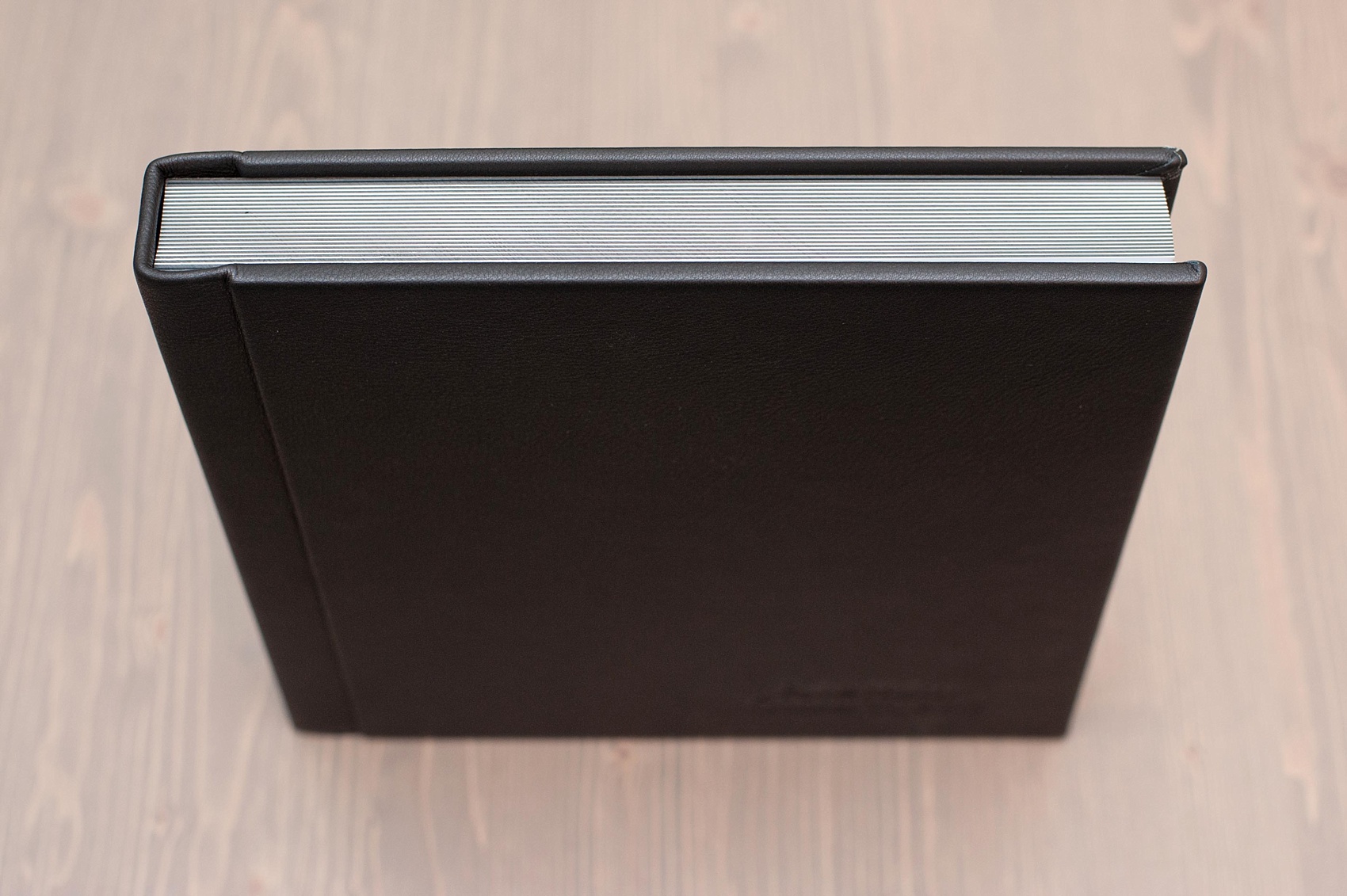 Mikkel Paige Photography black leather, fine-art wedding album option with thick pages.